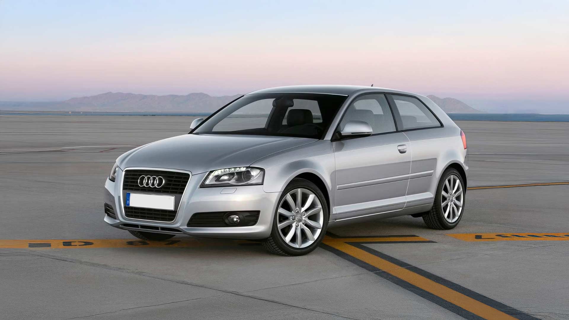 silver audi a3 8p hatchback on air field during sunset