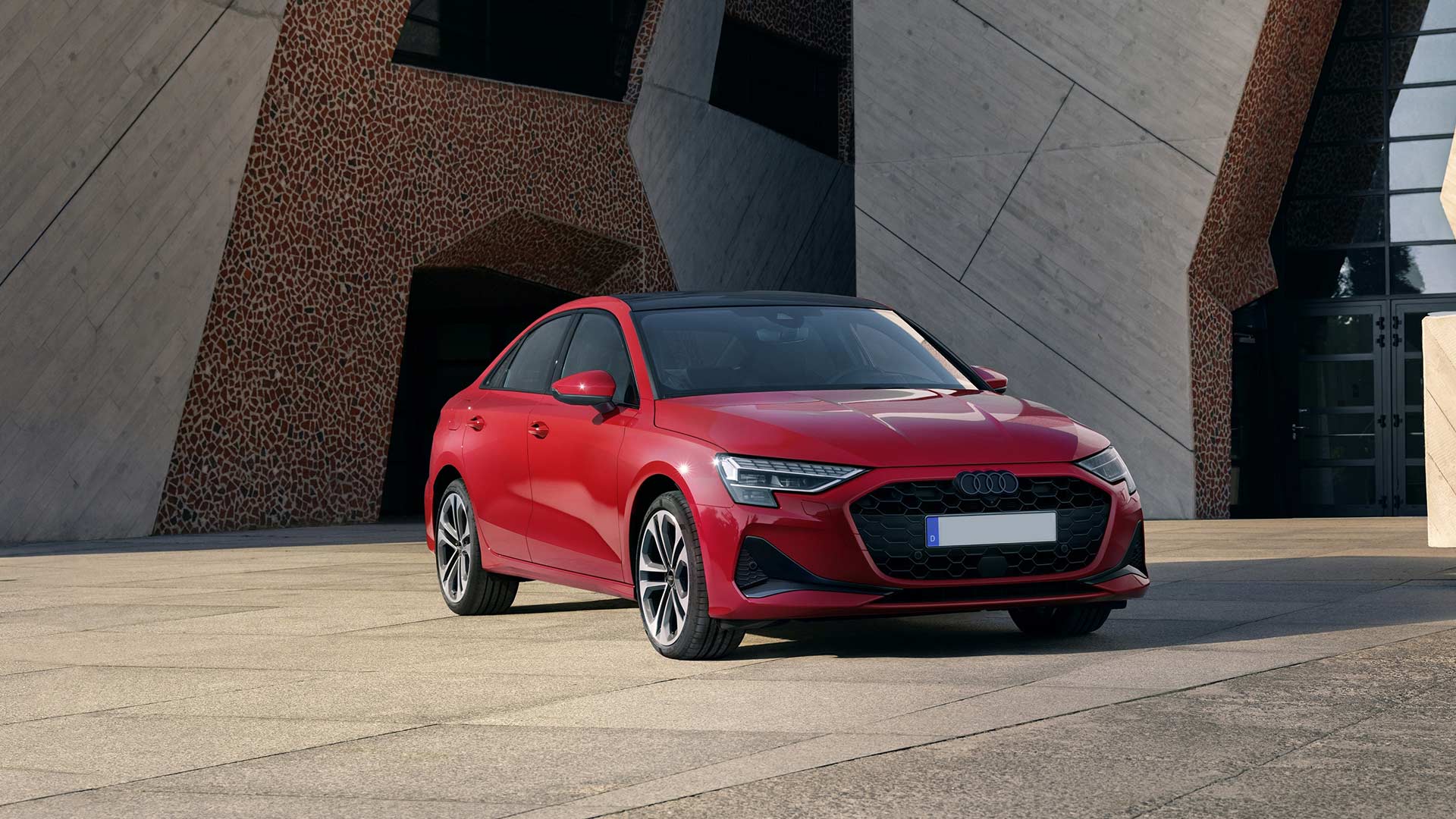 static shot of red audi a3 8y next to abstract geometric building